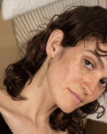 Image of lady's face wearing Judith Benita Deia twist earrings