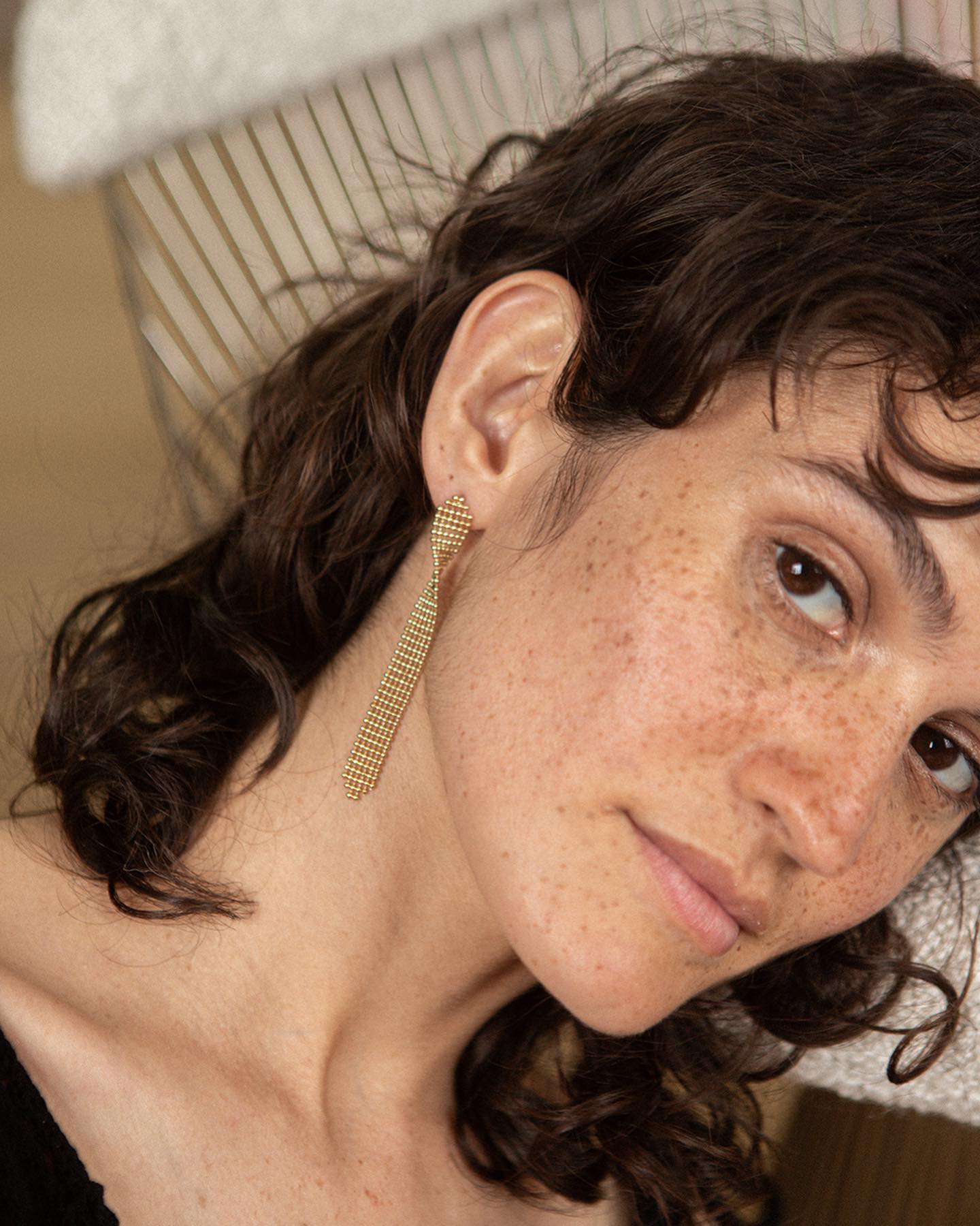 Image of lady's face wearing Judith Benita Deia twist earrings