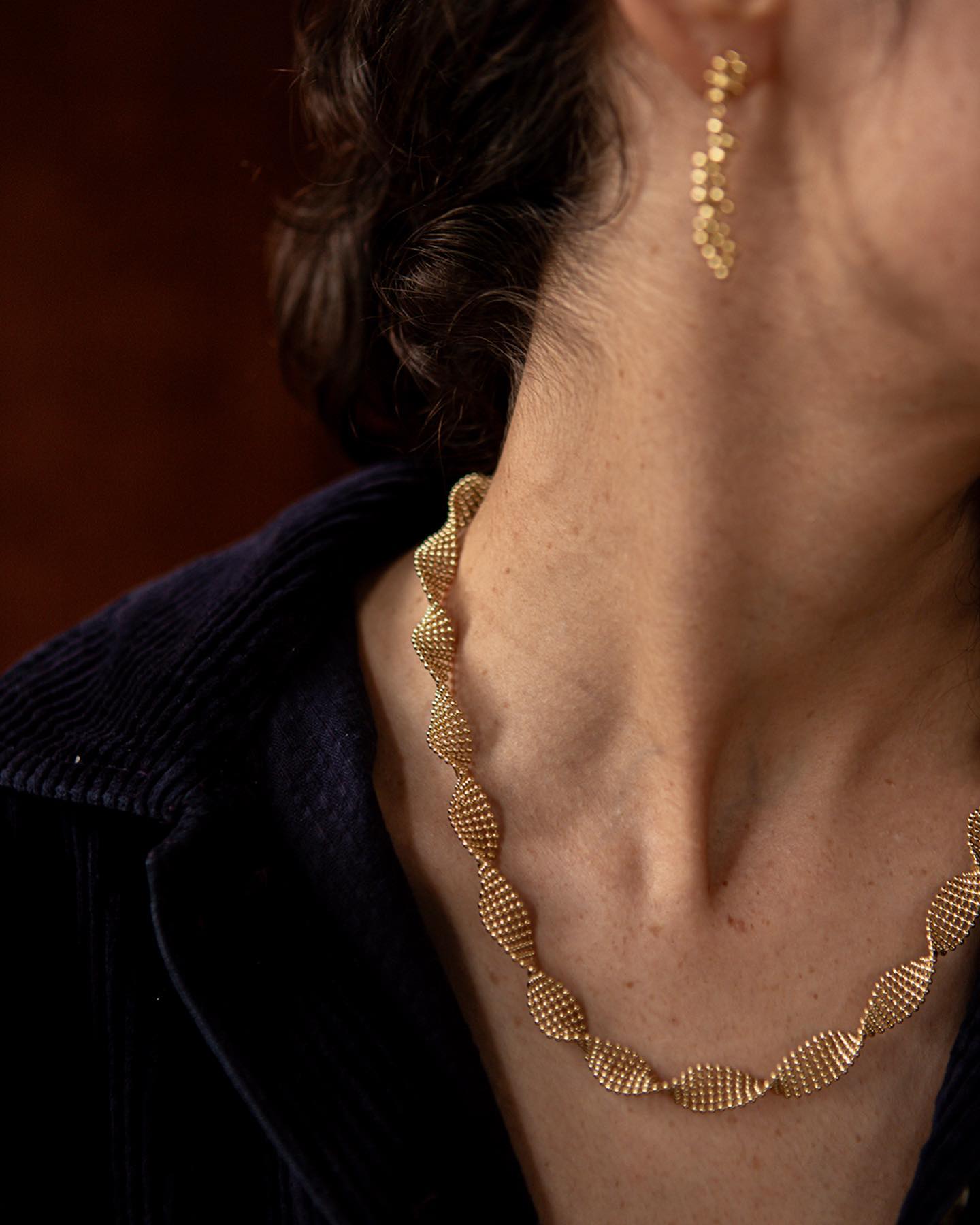 closeup of lady's neck wearing Judith Benita Deia twist necklance