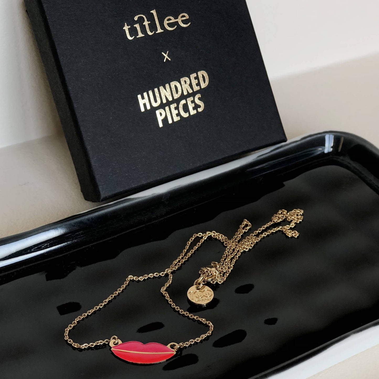 Titlee lips necklace on tray