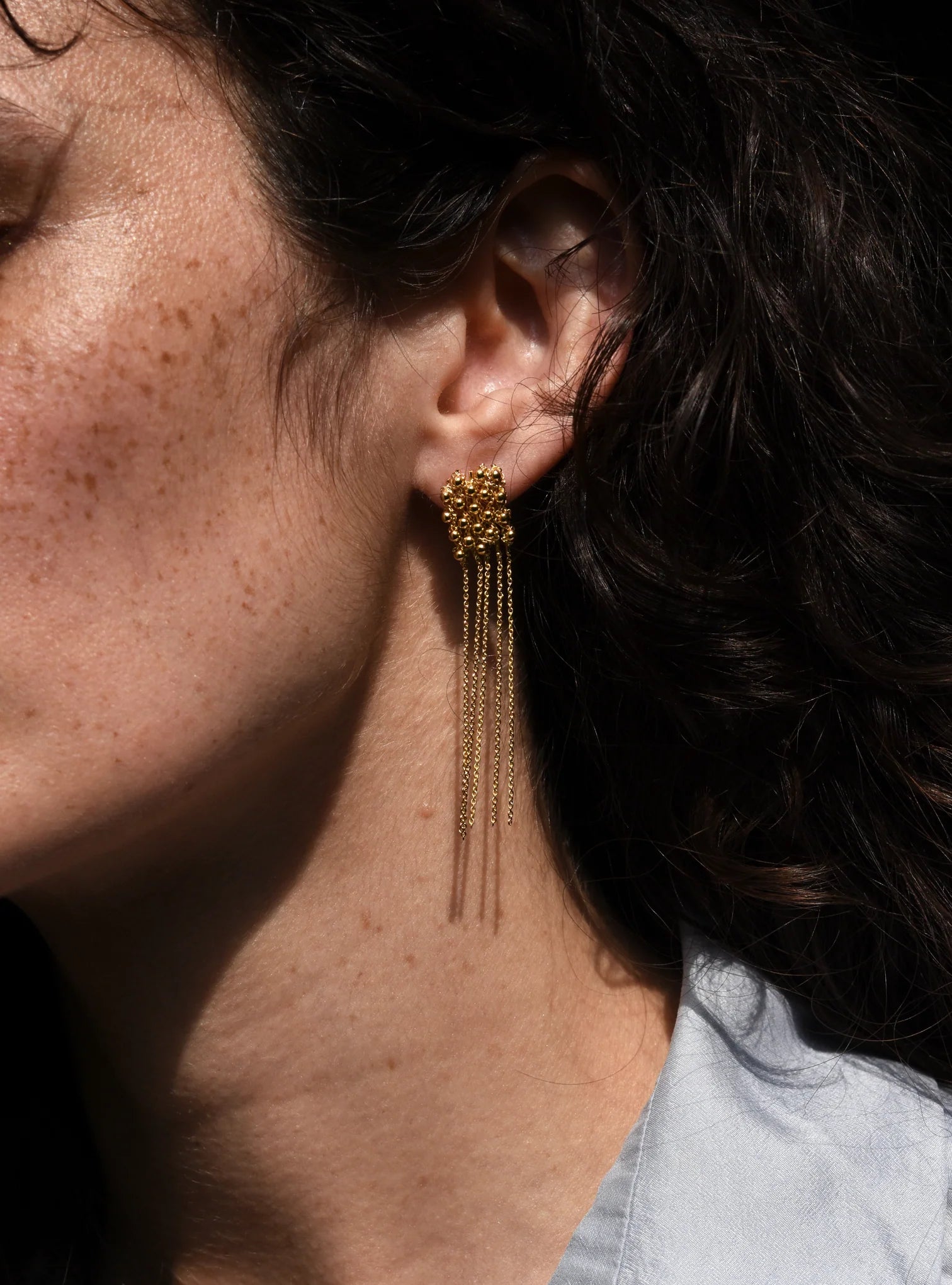 closeup of lady wearing Judith Benita Arabesque earrings