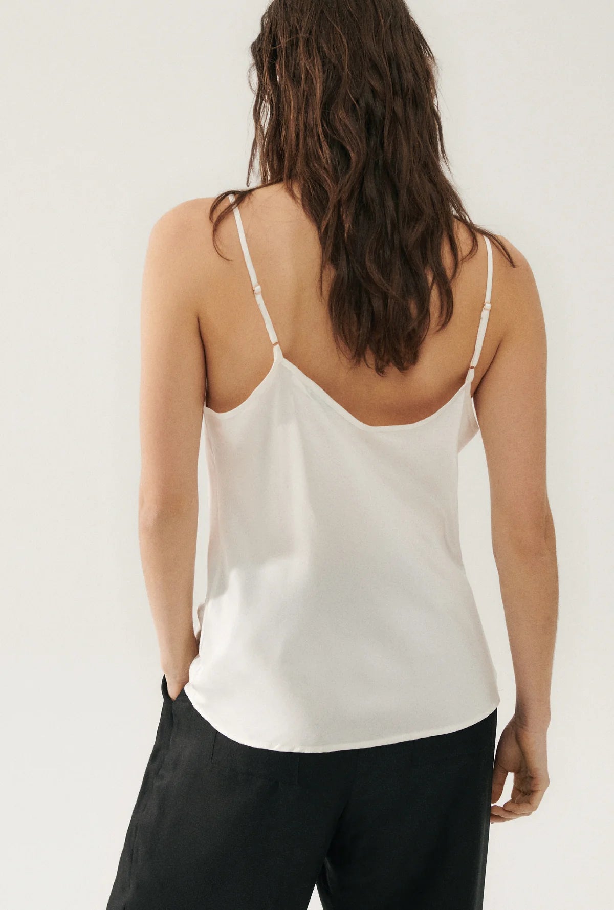 lady wearing white cami top back shot