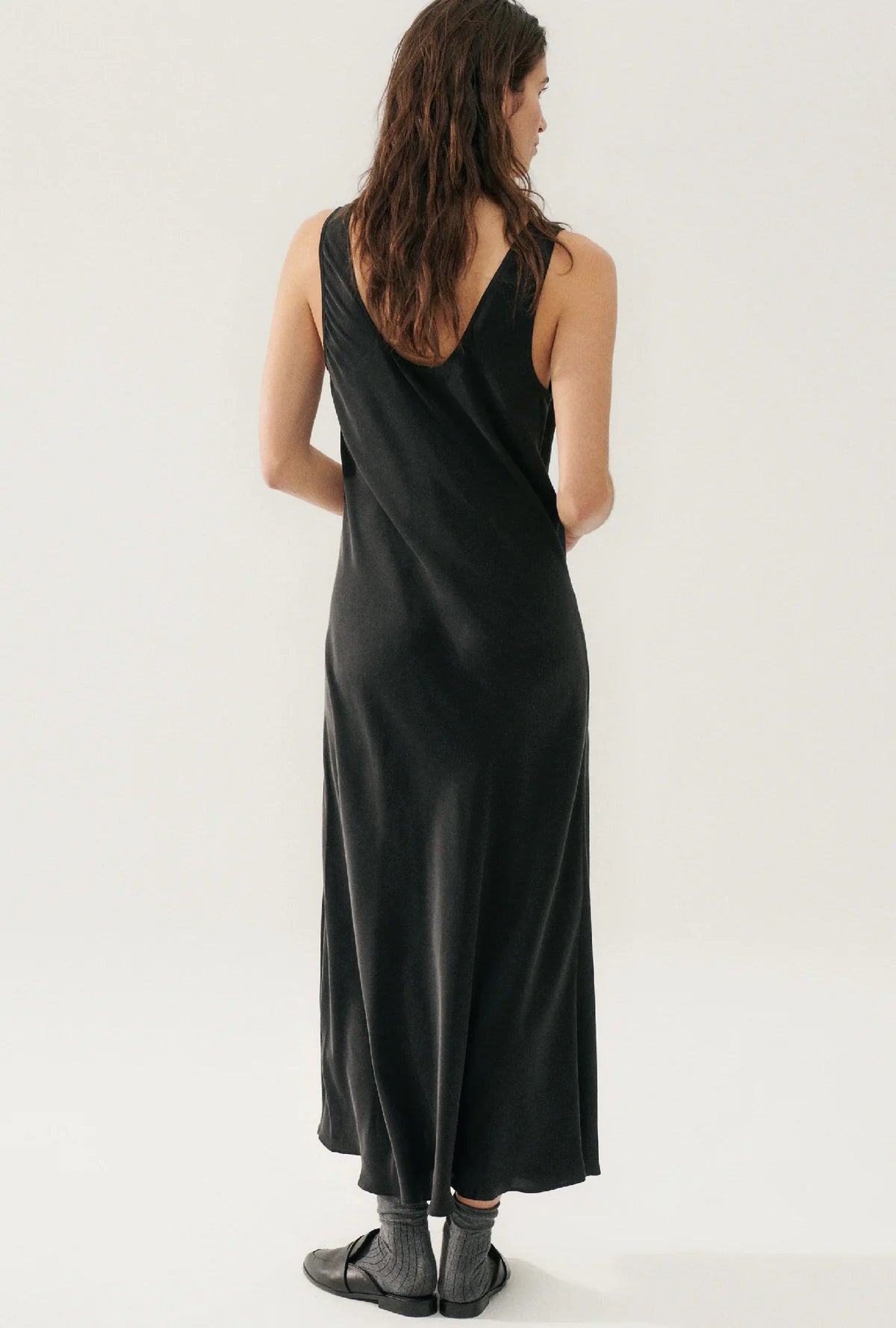 model wearing black scoop silk dress