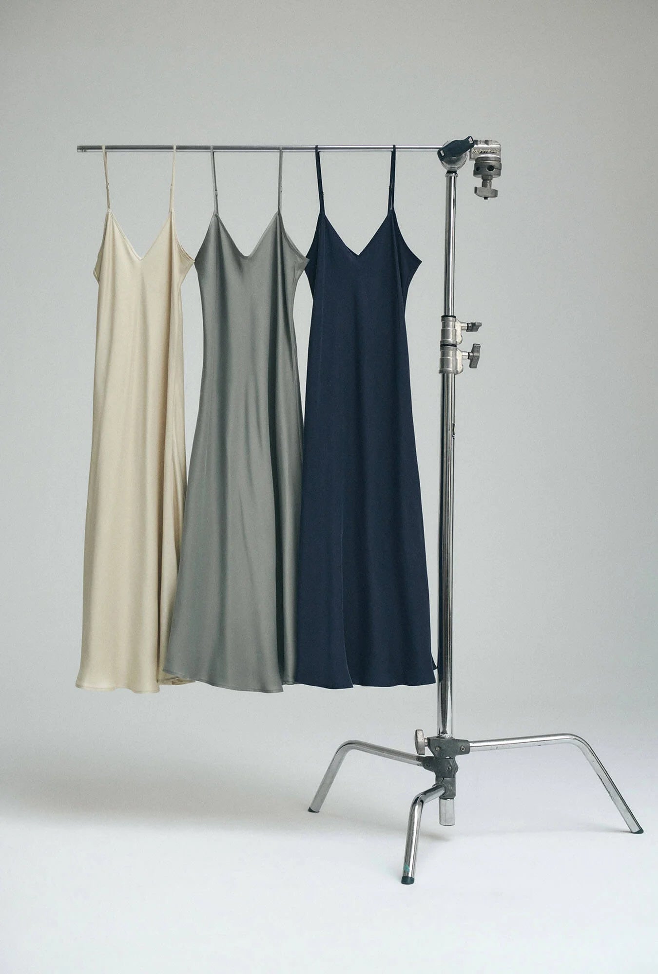 3 silk laundry slip dresses on a rack