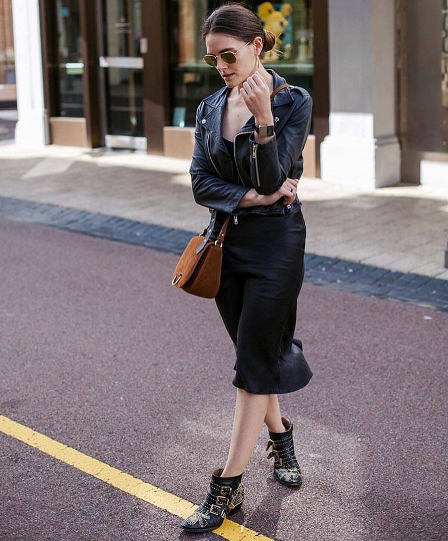 lady wearing black silk dress with leather jacket and boots